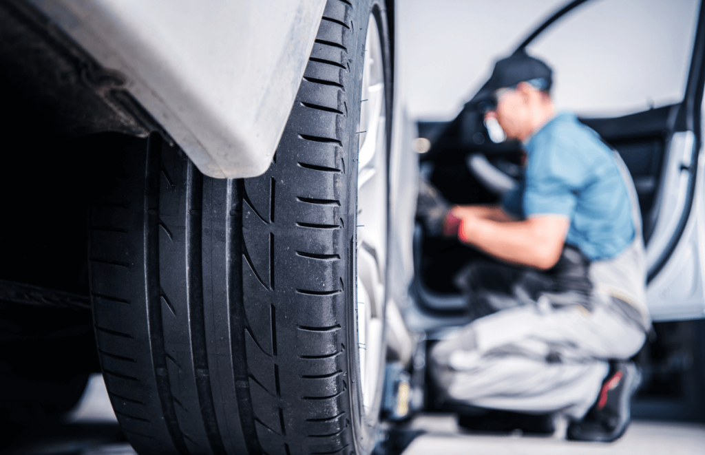 Vehicle Technician servicing a white car