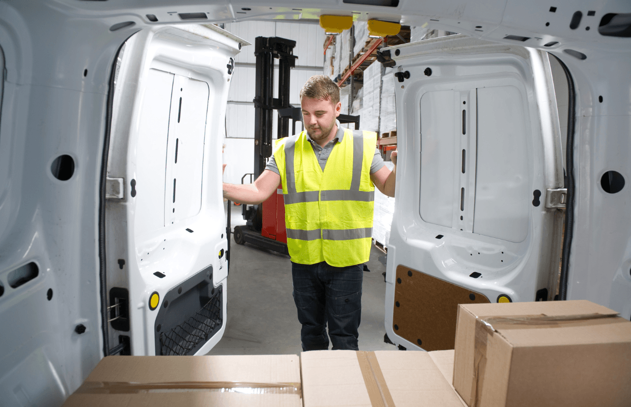 Transport and Logistics staffing Transport and Logistics worker in a high vis jacket closing a van door
